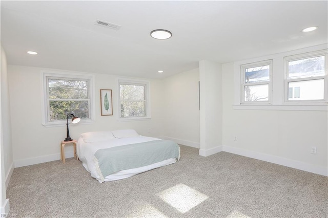 carpeted bedroom featuring recessed lighting, visible vents, and baseboards