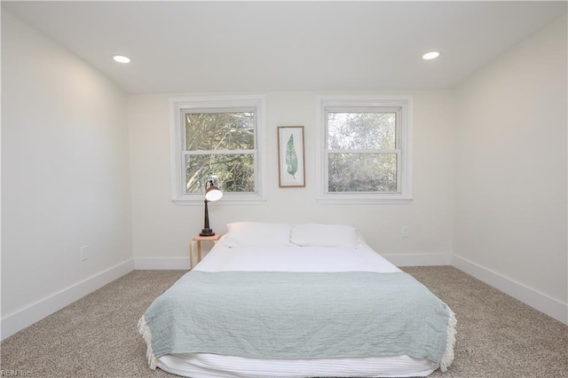 carpeted bedroom featuring recessed lighting and baseboards