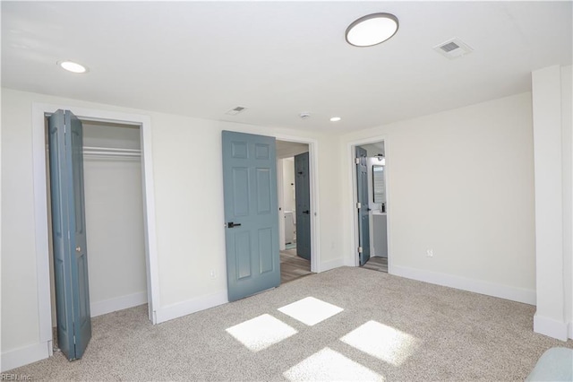 unfurnished bedroom with carpet, recessed lighting, a closet, visible vents, and baseboards