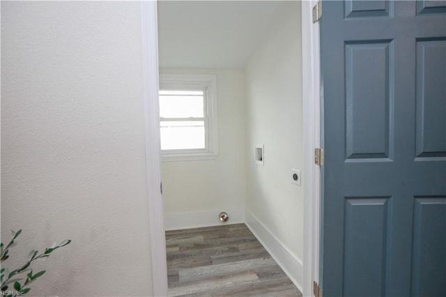 clothes washing area featuring hookup for a washing machine, hookup for an electric dryer, baseboards, and wood finished floors