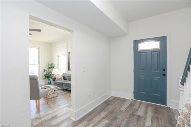 foyer featuring wood finished floors and baseboards