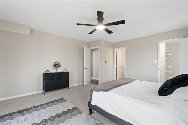 bedroom featuring light colored carpet, a ceiling fan, and baseboards