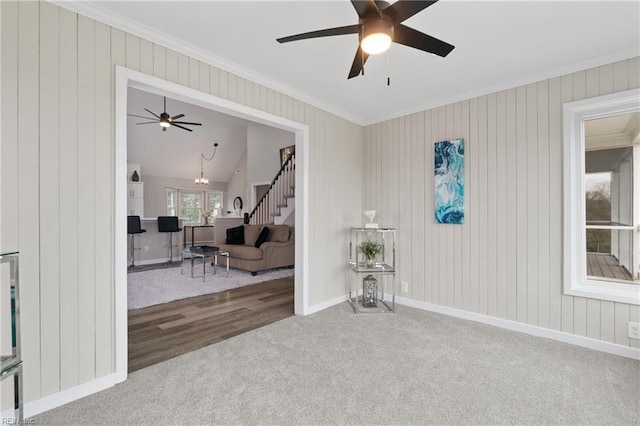 carpeted empty room featuring stairs, baseboards, and ornamental molding