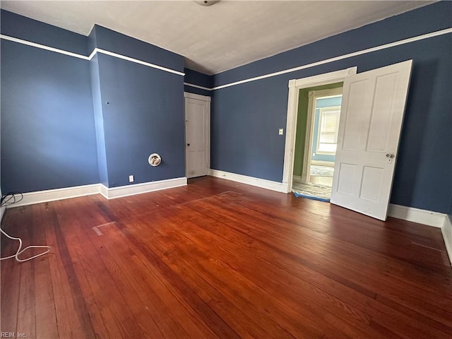 unfurnished bedroom featuring wood-type flooring and baseboards