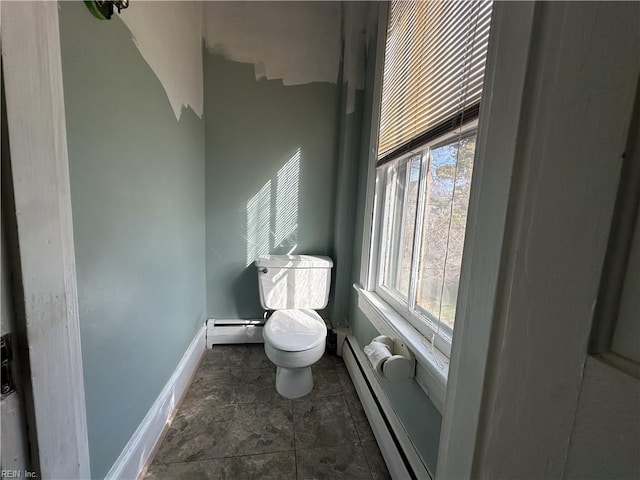 half bath featuring baseboards, toilet, and baseboard heating