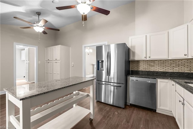 kitchen with appliances with stainless steel finishes, dark wood finished floors, and white cabinetry