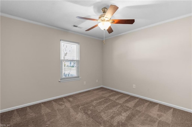 spare room featuring visible vents, crown molding, baseboards, carpet floors, and a ceiling fan