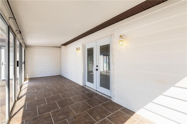 unfurnished sunroom with french doors