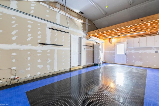 interior space with gas water heater and visible vents