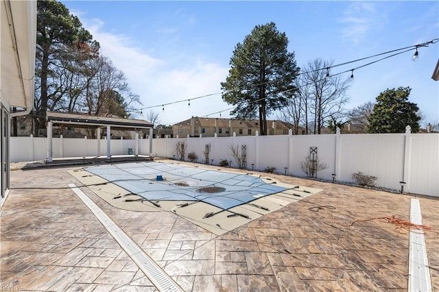 view of swimming pool featuring a fenced in pool, a patio, and a fenced backyard