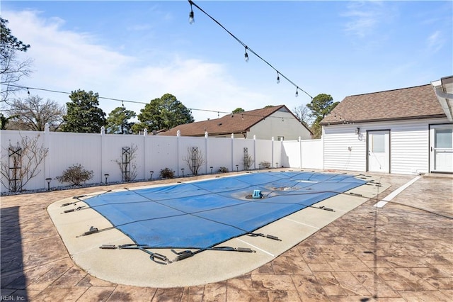 view of swimming pool with a patio area, a fenced in pool, and a fenced backyard