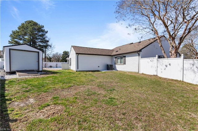 view of yard featuring an outbuilding, cooling unit, and fence