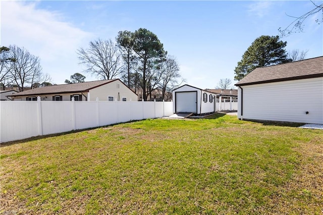 view of yard with a storage shed, an outbuilding, and fence