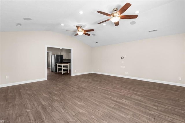 unfurnished living room featuring baseboards, visible vents, dark wood finished floors, lofted ceiling, and recessed lighting