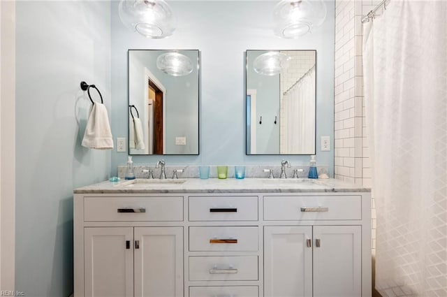 full bathroom with a sink, a shower with curtain, and double vanity