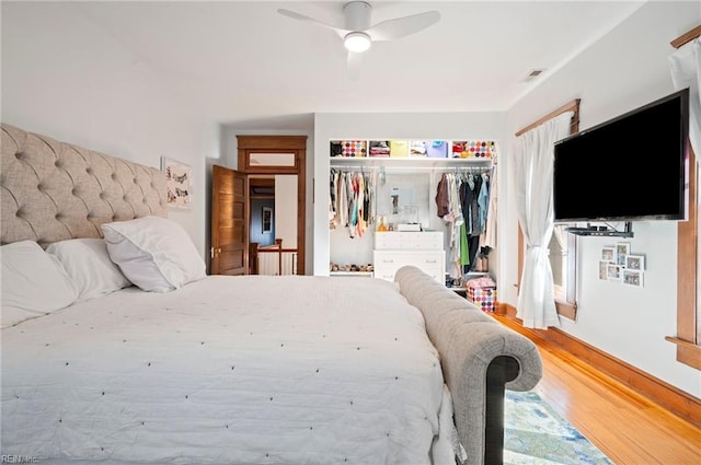 bedroom featuring a closet, visible vents, a ceiling fan, and wood finished floors