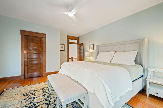 bedroom featuring ceiling fan, baseboards, and hardwood / wood-style floors