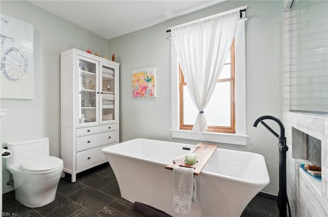 full bath featuring a soaking tub and toilet