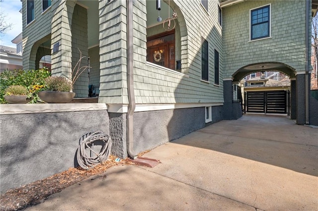 view of side of property with concrete driveway