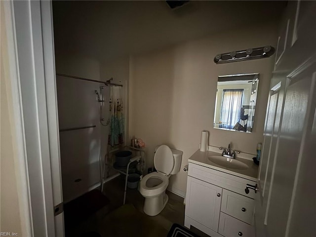 bathroom featuring toilet, a shower stall, and vanity