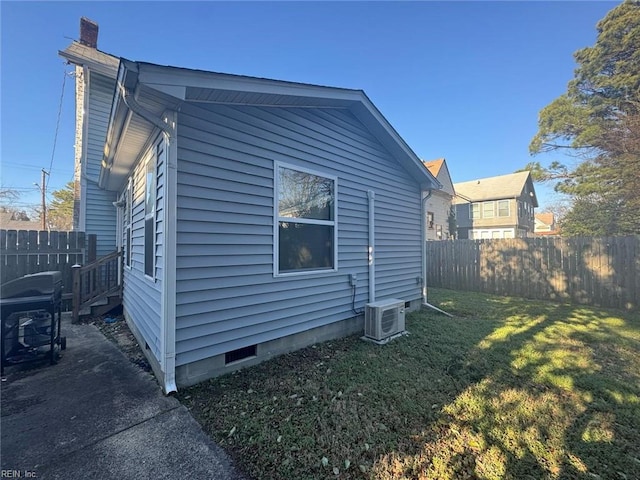 view of home's exterior featuring a lawn, a chimney, crawl space, fence, and ac unit