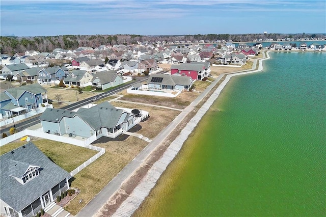 drone / aerial view with a residential view and a water view