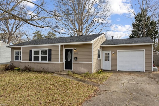 ranch-style home featuring brick siding, an attached garage, driveway, and a front yard