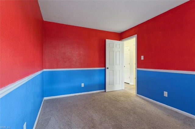 spare room with carpet flooring and baseboards