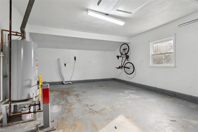 garage with baseboards and water heater