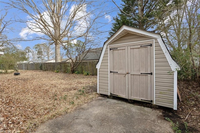 view of shed featuring fence