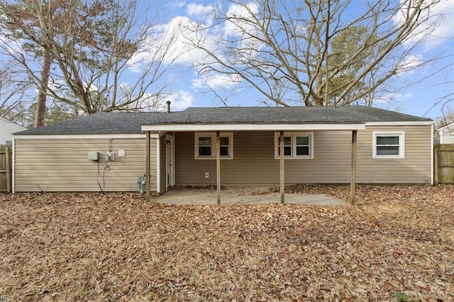 back of house with fence