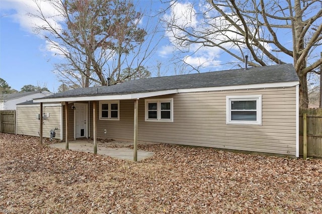 back of property featuring a patio area and fence