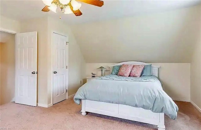 bedroom with lofted ceiling, carpet floors, a ceiling fan, and baseboards