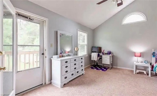 interior space featuring lofted ceiling, light carpet, a ceiling fan, and baseboards