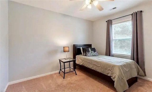 bedroom with ceiling fan, carpet floors, visible vents, and baseboards