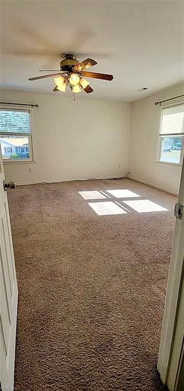 carpeted empty room featuring ceiling fan