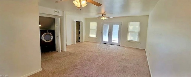 doorway to outside featuring light carpet, visible vents, baseboards, french doors, and washer / clothes dryer