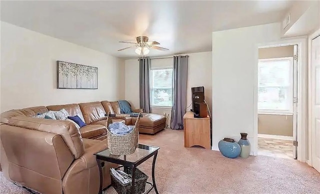 living room with ceiling fan and carpet flooring