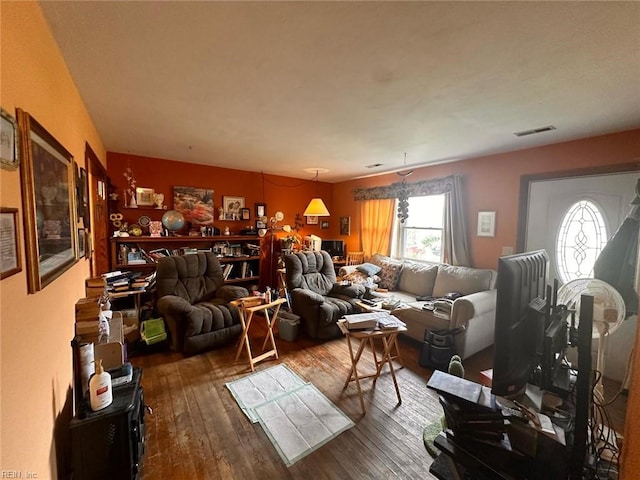 living room featuring wood-type flooring and visible vents
