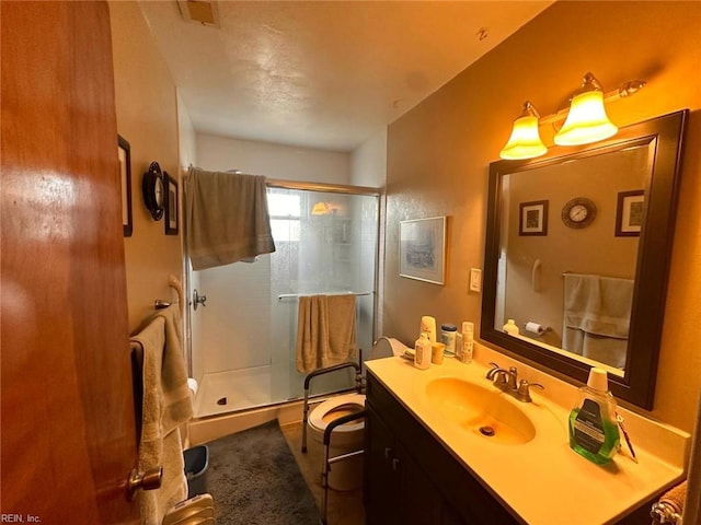 full bathroom featuring a stall shower, visible vents, and vanity