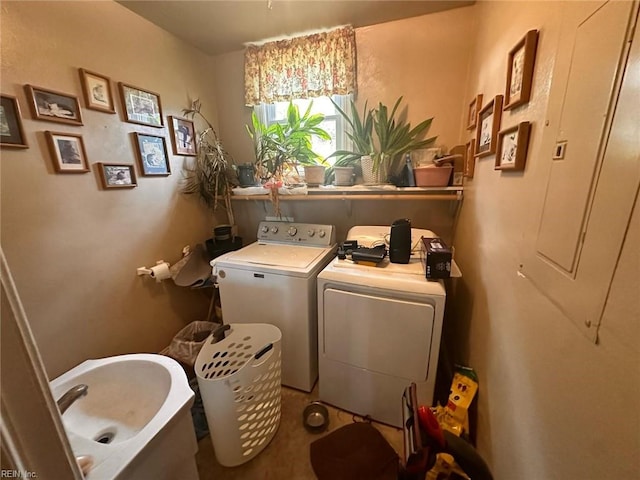 laundry area featuring laundry area, a sink, and washing machine and clothes dryer