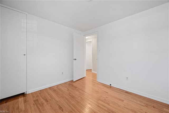 unfurnished bedroom with light wood finished floors and baseboards