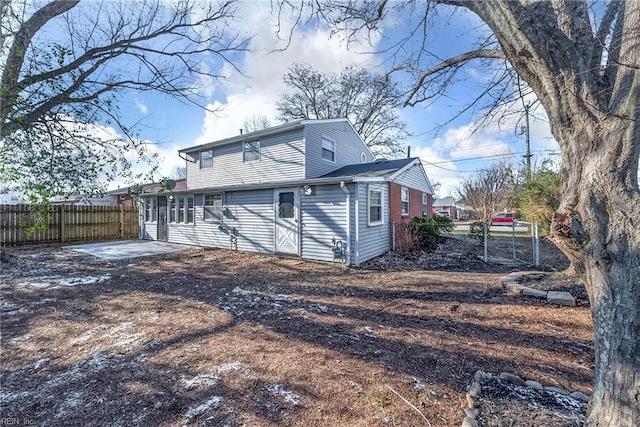 back of house featuring fence