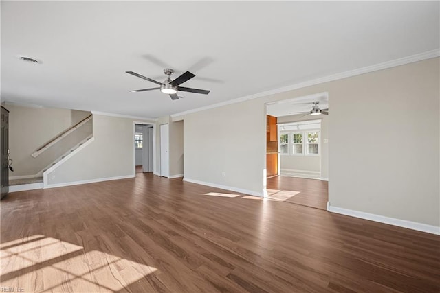 unfurnished living room featuring baseboards, visible vents, stairway, wood finished floors, and crown molding