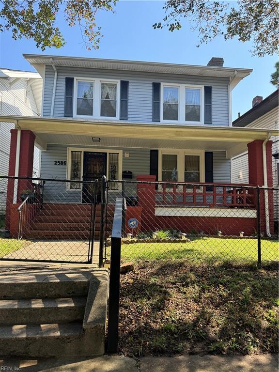 view of front of home featuring a fenced front yard, a porch, a chimney, and a gate