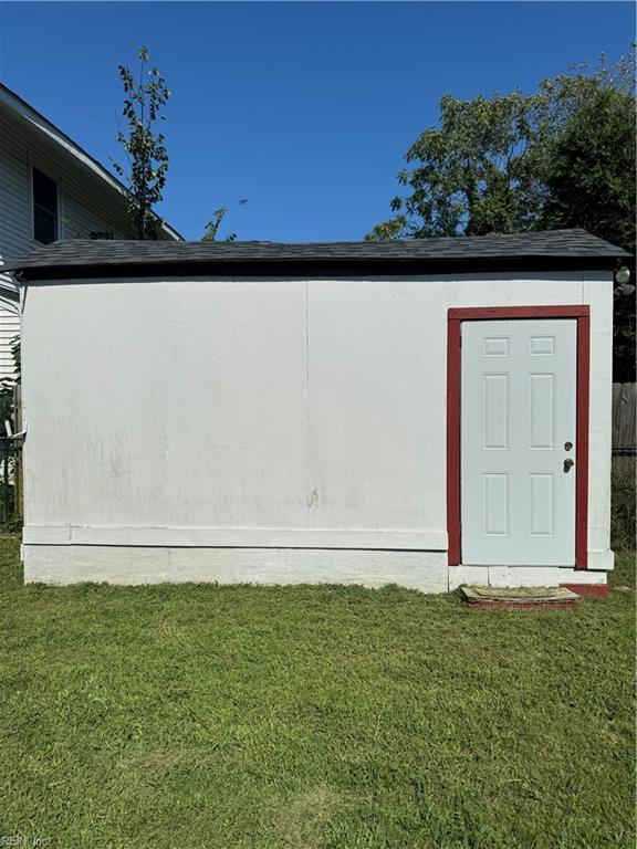 view of shed with fence