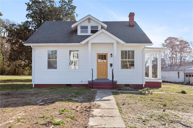 bungalow-style home with crawl space, a chimney, and a shingled roof