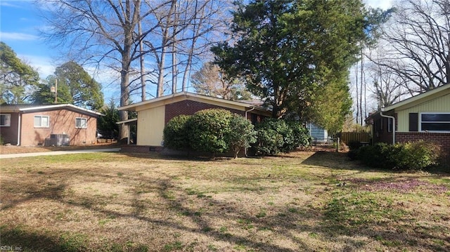 view of property exterior with a yard and brick siding