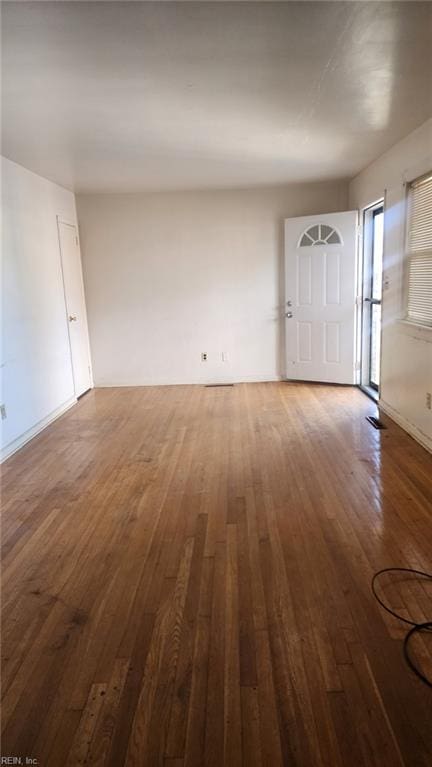 spare room with wood-type flooring