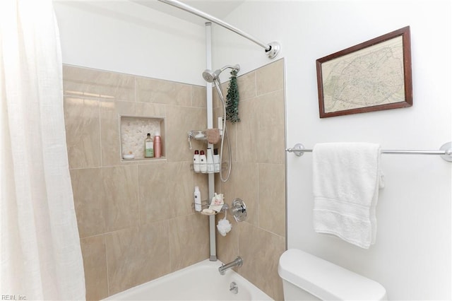 bathroom with toilet and shower / bath combo with shower curtain